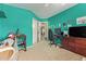 Stylish bedroom featuring an open door, neutral carpet, teal walls, and a workstation for gaming at 1333 E Rockledge Rd, Phoenix, AZ 85048