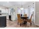 Bright dining area featuring a round table, wicker chairs, and large windows draped with sheer white curtains at 1333 E Rockledge Rd, Phoenix, AZ 85048