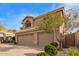 Two-story home with tile roof, three-car garage, desert landscaping, and manicured shrubs at 1333 E Rockledge Rd, Phoenix, AZ 85048