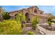 Landscaped front yard showcasing desert plants, shrubs, rocks, and a brick walkway at 1333 E Rockledge Rd, Phoenix, AZ 85048