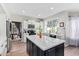 Island kitchen featuring stainless appliances, white marble backsplash, and granite countertops at 1333 E Rockledge Rd, Phoenix, AZ 85048