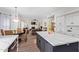 Open-concept living room and dining area featuring an island with granite countertop and a fireplace at 1333 E Rockledge Rd, Phoenix, AZ 85048