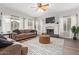 Bright living room with a fireplace, ceiling fan, sofas, area rug and hardwood floors at 1333 E Rockledge Rd, Phoenix, AZ 85048