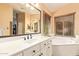 Main bathroom with double sink vanity, large mirror, soaking tub, and window providing natural light at 1333 E Rockledge Rd, Phoenix, AZ 85048