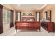 Serene main bedroom with a wooden sleigh bed, soft carpet, and ample natural light at 1333 E Rockledge Rd, Phoenix, AZ 85048