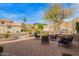 Brick patio with outdoor seating including lounge chairs, lush landscaping, and mountain views at 1333 E Rockledge Rd, Phoenix, AZ 85048