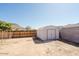 Wide shot of the backyard with a fence, storage shed and partial view of the house at 13425 N 16Th Ave, Phoenix, AZ 85029