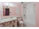 Bathroom featuring a tub and shower combination, vanity with sink and a large mirror at 13425 N 16Th Ave, Phoenix, AZ 85029