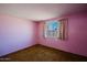 Bedroom featuring pink walls, carpet flooring, and a window with curtains at 13425 N 16Th Ave, Phoenix, AZ 85029