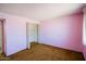 Bedroom showcasing a closet with doors, carpet flooring, and pink walls at 13425 N 16Th Ave, Phoenix, AZ 85029