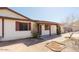 Side view of home featuring desert landscaping, shuttered windows, and covered entryway at 13425 N 16Th Ave, Phoenix, AZ 85029