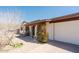 Welcoming front of home with desert landscaping, mature shrubbery and an attached two-car garage at 13425 N 16Th Ave, Phoenix, AZ 85029