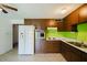 Bright kitchen featuring white appliances, ample cabinetry, and durable tile flooring at 13425 N 16Th Ave, Phoenix, AZ 85029