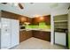 Functional kitchen with wood cabinetry, white appliances, and ample countertop space at 13425 N 16Th Ave, Phoenix, AZ 85029