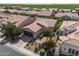 Aerial view of home showcasing desert landscaping, tile roof, and proximity to green fields and mountains at 1357 E Elysian Pass, Queen Creek, AZ 85140