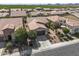 Aerial view of home showcasing desert landscaping, tile roof, and proximity to green fields and mountains at 1357 E Elysian Pass, Queen Creek, AZ 85140