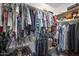 Well-organized closet with hanging clothes, shelves, and an assortment of shoes neatly arranged at 1357 E Elysian Pass, Queen Creek, AZ 85140