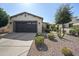 Charming single-story home with a desert-landscaped front yard and a two-car garage at 1357 E Elysian Pass, Queen Creek, AZ 85140