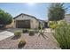 Charming single-story home featuring a low maintenance desert landscape and a large garage at 1357 E Elysian Pass, Queen Creek, AZ 85140