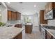 Modern kitchen featuring granite countertops, stainless steel appliances, and ample cabinet space at 1357 E Elysian Pass, Queen Creek, AZ 85140