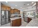 Modern kitchen featuring stainless steel appliances, granite countertops and custom cabinetry at 1357 E Elysian Pass, Queen Creek, AZ 85140