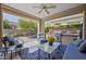 Covered patio with outdoor seating, ceiling fan, and a built-in grill at 1357 E Elysian Pass, Queen Creek, AZ 85140