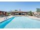 Inviting community pool with lounge chairs and clear blue water on a sunny day at 13700 N Fountain Hills Blvd # 327, Fountain Hills, AZ 85268