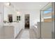 Elegant bathroom with double vanity, walk-in shower, and separate soaking tub at 16788 W Beth Dr, Goodyear, AZ 85338