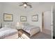 bedroom featuring twin beds with gray carpet, a ceiling fan and neutral decor at 16788 W Beth Dr, Goodyear, AZ 85338