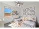 Charming bedroom with twin beds, playful decor, and ample natural light at 16788 W Beth Dr, Goodyear, AZ 85338
