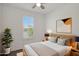 Relaxing bedroom features plantation shutters, a ceiling fan and neutral decor at 16788 W Beth Dr, Goodyear, AZ 85338