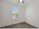 Bright bedroom with plantation shutters, a ceiling fan and neutral color carpet at 16788 W Beth Dr, Goodyear, AZ 85338