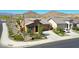 Charming exterior view of a home showcasing manicured landscaping, a two-car garage, and desert surroundings at 16788 W Beth Dr, Goodyear, AZ 85338