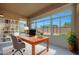 Well-lit home office offers a workspace with backyard views, a comfortable chair, and ample natural light at 16788 W Beth Dr, Goodyear, AZ 85338