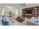 Bright and airy living room with stylish furniture, built-in shelving, and open access to the dining area at 16788 W Beth Dr, Goodyear, AZ 85338