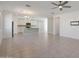 Open-concept living area with tile flooring, ceiling fan, and a combined kitchen view at 16788 W Beth Dr, Goodyear, AZ 85338