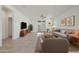Cozy living room featuring a comfortable seating arrangement, a ceiling fan, and sliding doors to the backyard at 16788 W Beth Dr, Goodyear, AZ 85338