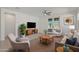 Inviting living room boasts a stylish decor, a ceiling fan, and access to the outdoor patio through French doors at 16788 W Beth Dr, Goodyear, AZ 85338