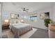 Bright main bedroom with a ceiling fan, a large window and neutral decor at 16788 W Beth Dr, Goodyear, AZ 85338