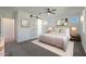 Well-lit main bedroom with gray carpet, a ceiling fan and walk-in closet access at 16788 W Beth Dr, Goodyear, AZ 85338