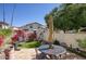 Private backyard with a tiled patio, seating, lush flowers, and mountain views at 1803 E Hayward Ave # 1, Phoenix, AZ 85020