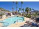 Community pool with a jacuzzi and plenty of lounge chairs, framed by mature palm trees at 1803 E Hayward Ave # 1, Phoenix, AZ 85020