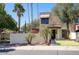 A charming two-story home featuring desert landscaping with multiple palm trees and bougainvillea at 1803 E Hayward Ave # 1, Phoenix, AZ 85020