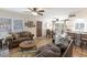 Open-concept living room features tile flooring, comfortable seating, and a view into the dining area at 1803 E Hayward Ave # 1, Phoenix, AZ 85020