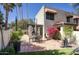 Charming back patio with stone tiles, seating area, pergola, and beautiful landscaping at 1803 E Hayward Ave # 1, Phoenix, AZ 85020