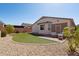 Well maintained backyard featuring manicured artificial grass, decorative rock and a covered patio at 18430 E Azul Ct, Gold Canyon, AZ 85118