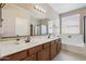 Bright bathroom featuring double sinks, a soaking tub, and plenty of natural light at 18430 E Azul Ct, Gold Canyon, AZ 85118