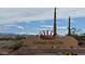 Entrada del Oro community sign set against scenic desert mountain backdrop, showcasing the community's charm at 18430 E Azul Ct, Gold Canyon, AZ 85118