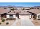 Charming single-story home with a tile roof, desert landscaping and a paved walkway to the front door at 18430 E Azul Ct, Gold Canyon, AZ 85118