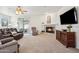 Cozy living room with a fireplace, TV and sliding glass door to patio at 18430 E Azul Ct, Gold Canyon, AZ 85118